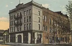 A photograph of Morton Theatre, a brick three-story building on a street corner in Athens, Georgia