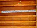 Wooden beam ceiling with an inscription indicating the date of its construction.