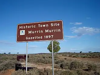 Sign and ruins of townsite