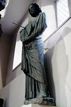 Sculpture of a man holding a functioning tide dial