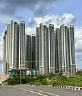 Residential skyscraper complex with a white and beige exterior.