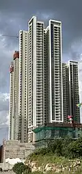 Residential skyscraper complex with a white and beige exterior.