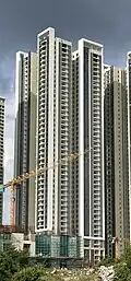 Residential skyscraper complex with a white and beige exterior.