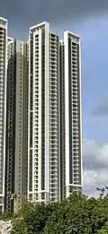 Residential skyscraper complex with a white and beige exterior.