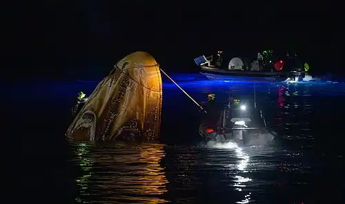 Support teams approach Crew Dragon Endeavour after splashdown in the Pacific Ocean