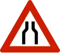 Road narrows on both sides.
