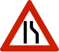 Road narrows on right side.
