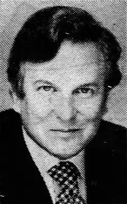 Black-and-white headshot of Branden in a suit