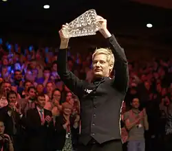 Robertson holds the Masters trophy aloft after his victory in 2012