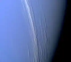 A composite black-and-white photograph showing cirrus clouds over the surface of Mars