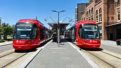 An eastbound CAF Urbos 100 at Civic stop
