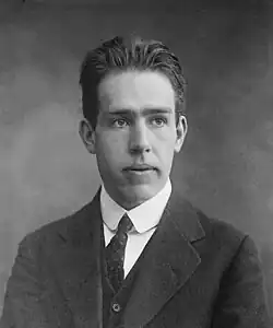 Black and white portrait photograph of a man in a suit