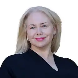Headshot of Krieger wearing black glasses at a press conference
