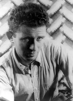 monochrome photograph of a man in an open-necked shirt