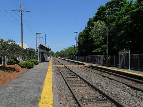 A railway station with two tracks and two low-level side platforms