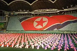 Thousands of people at the Arirang Mass Games form an image of the North Korean flag by holding up coloured cards