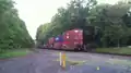 Norfolk Southern westbound train on the Lehigh Line passing through a crossing near Flemington, New Jersey, Picture 3- in back of train part one