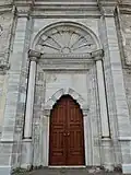 Central entrance to the courtyard, with sun motif above the doorway