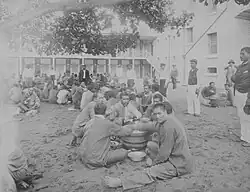 Prison inmates on Oʻahu eating poi circa 1890