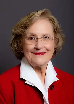 Head and shoulders of a smiling 60ish woman with blond hair