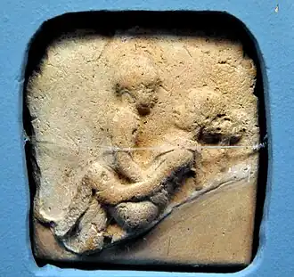 A clay plaque of a couple having sexual intercourse in the missionary position, from Old Babylon (2nd millennium B.C.)