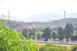Tree covered hills of Valencia with Magic Mountain theme park in background