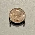 One shilling coin stamped "DUD"