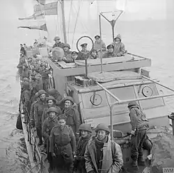 Soldiers crowded on the deck of a Motor Torpedo Boat