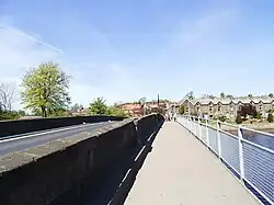 View of the modern footbridge pathway attached to the historic Otley Bridge