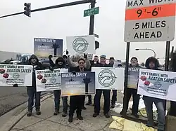 PASS members outside holding signs that say Don't Gamble with Aviation Safety and Aviation Safety is Our Only Business.