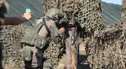 A PLAGF soldier armed with a QBZ-191 rifle and a QSZ-92 pistol holstered during the 2021 International Army Games
