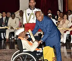 President Ram Nath Kovind felicitates Hiralal Yadav with Padma Shri