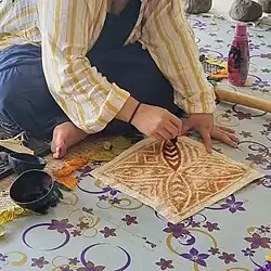 Painting details onto the dried piece.