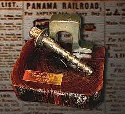 Example of the original construction 53&nbsp;lb/yd (26&nbsp;kg/m) inverted "U" rail aka "Bridge" rail, "screw" spike, and lignum vitae tie used to build the Panama Railroad from 1851 to 1855