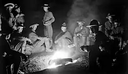Members of the United States Army 16th Infantry Regiment gathered around a campfire in 1916 during the Pancho Villa Expedition