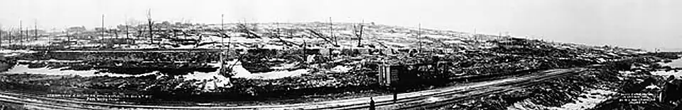Panoramic view over train tracks to destroyed cityscape