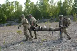 Pararescue specialists from the 103d Rescue Squadron, NY, evacuate a casualty during a Combat Search & Rescue exercise at Northern Strike 2018