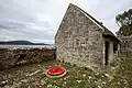 Binding stone at Parke's Castle in Co. Leitrim, Ireland with a red cart wheel placed on top