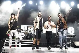 Country music band Parmalee, performing on a stage.