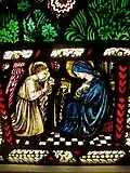 One of three vignettes at the base of the window. The Annunciation. Gabriel tells Mary the good news.