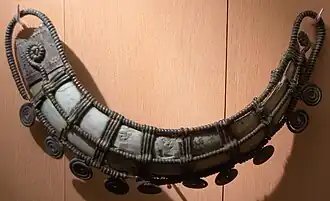 Circa 1200 BC, jewel worn on the hip, made of bronze lacework around a suidae canine, found in a burial.