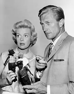 Patricia Donahue and Richard Denning in a black-and-white TV scene.