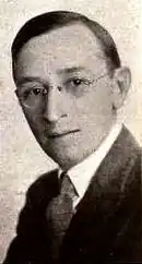 Black and white portrait photograph of a middle-aged man in formal attire