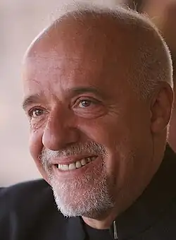 A close up of a smiling man.