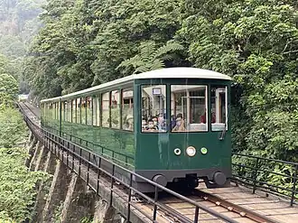 Hong Kong Peak Tramways sixth generation Peak Tram car as viewed from Barker Road, en route to The Peak Terminus