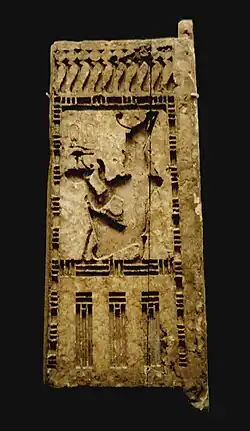 Wooden doorjamb, originally covered with gold leaf and inlaid glass, representing Seheruibre Petubastis III making an offering,[1] Louvre Museum.