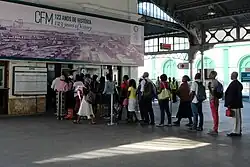 Photo of people waiting in line at a train station