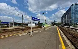 Station platforms before 2020s modernisation with Śródmieście skyline in the background, 2019