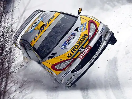 Image 1Juuso Pykälistö in his Peugeot 206 WRC during the 2003 Swedish Rally. Peugeot is a major French car brand, part of the PSA Peugeot Citroën group.