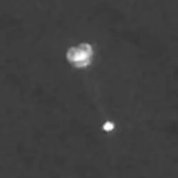 Parachute of Phoenix lander open as it descends in the Martian atmosphere. This picture was taken by the Mars Reconnaissance Orbiter with HiRISE